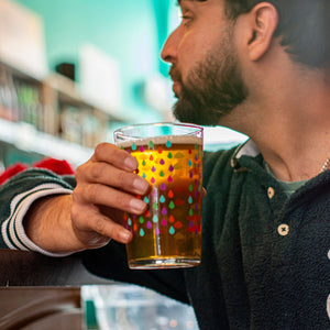 Man holding a Big Drop Alcohol-Free beer in a casual setting